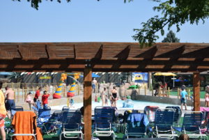 People playing in Turtle Bay as seen from behind lounge chairs