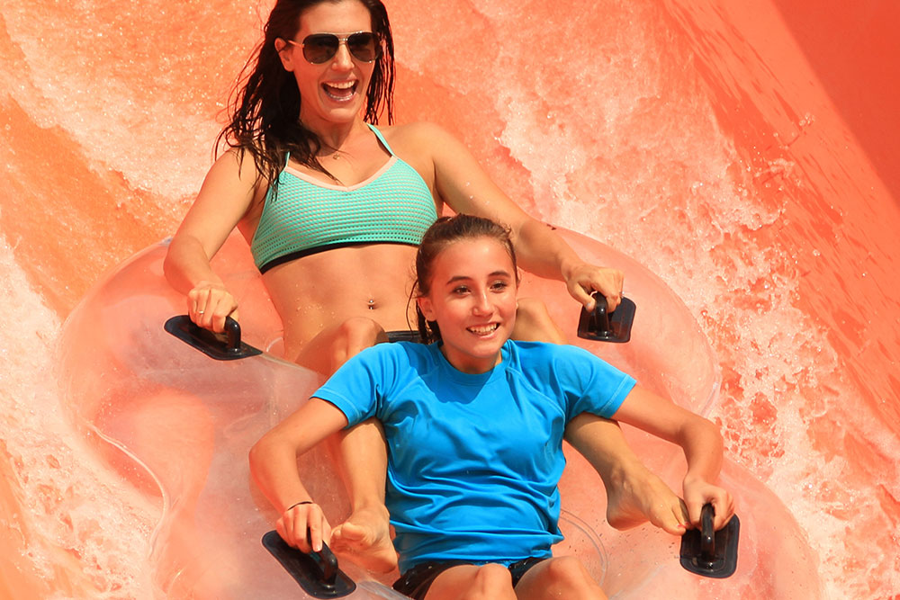 Mother and daughter sliding at Double Dare attraction, Water World